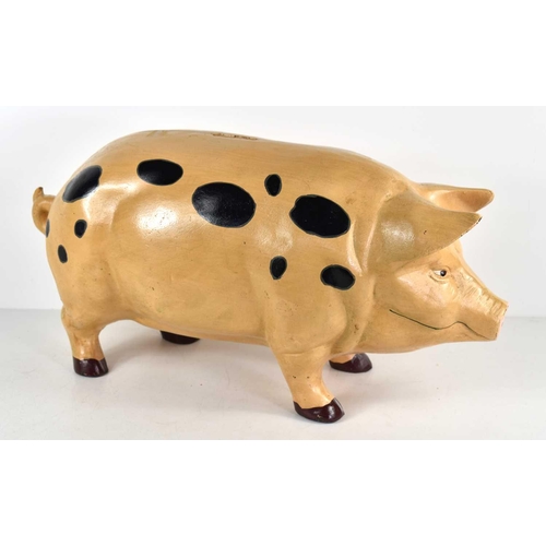 287 - A large cast iron money bank in the form of a standing pig, 45cm wide by 23cm.