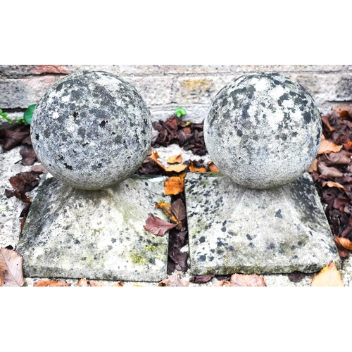 288 - A pair of stone gate post caps of ball form.