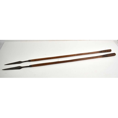 303 - Two African tribal spears with wooden shafts and carved handles, 100cm.