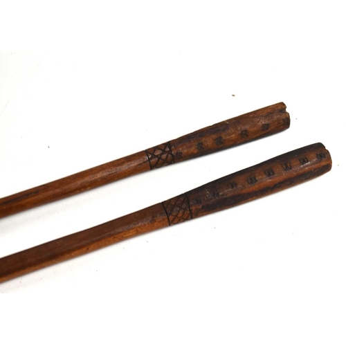 303 - Two African tribal spears with wooden shafts and carved handles, 100cm.