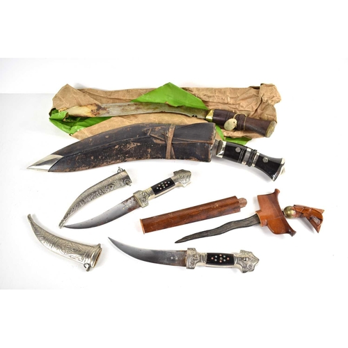 312 - A selection of Khukri Gurka knife, a further example without sheath, an Indian dress dagger, and an ... 