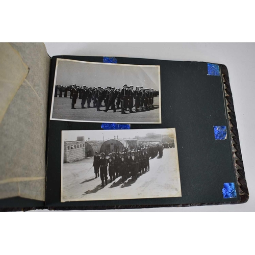 316 - A WWII photograph album containing photos of Jerusalem in 1945, a ship on fire at sea, HMS tracker, ... 