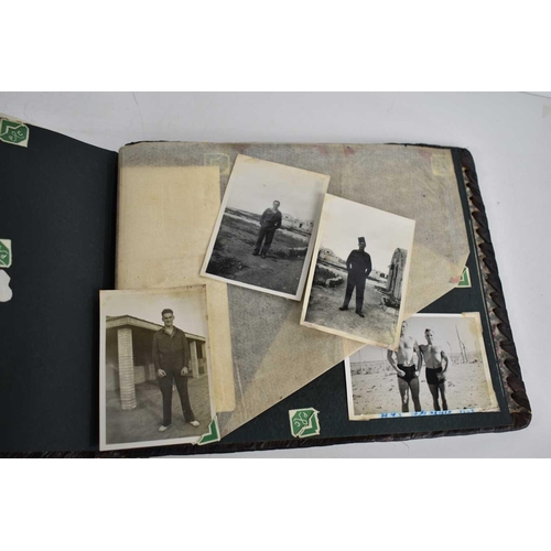 316 - A WWII photograph album containing photos of Jerusalem in 1945, a ship on fire at sea, HMS tracker, ... 