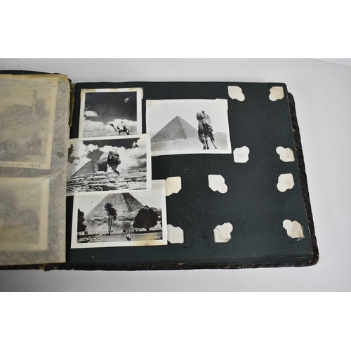 316 - A WWII photograph album containing photos of Jerusalem in 1945, a ship on fire at sea, HMS tracker, ... 