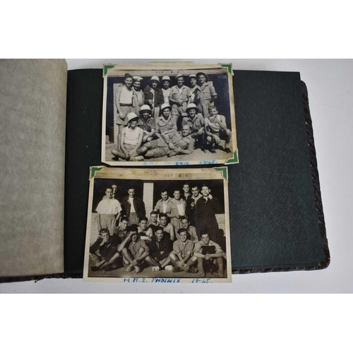 316 - A WWII photograph album containing photos of Jerusalem in 1945, a ship on fire at sea, HMS tracker, ... 