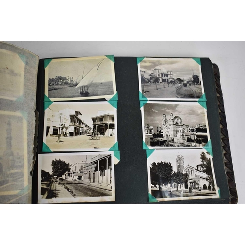 316 - A WWII photograph album containing photos of Jerusalem in 1945, a ship on fire at sea, HMS tracker, ... 