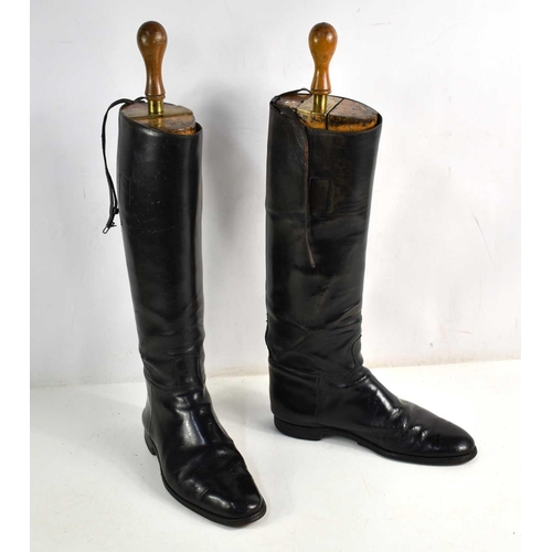 322 - A pair of early 20th century black leather military riding boots with trees, made by Peal & Co, the ... 