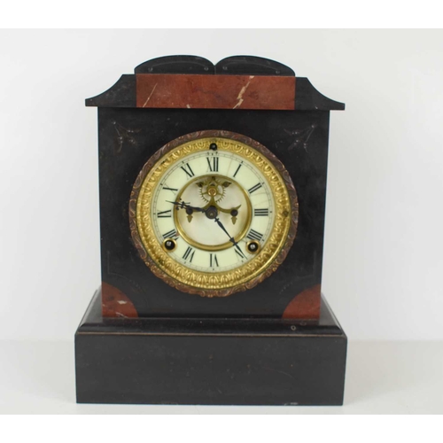 324 - A Victorian slate mantle clock having an Ansomia movement and Brocot escapement,