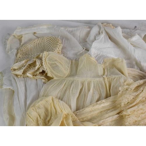 341 - A group of vintage textiles and childrens clothes to include a fine Victorian silk and lace christen... 