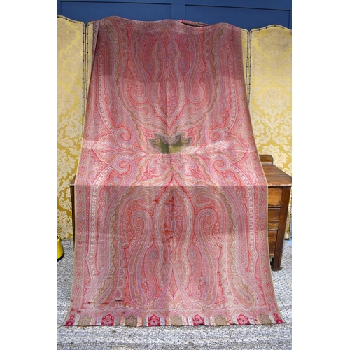 342 - A 19th century Paisley bed cover, in shades of red, pink and green, 154cm by 314cm