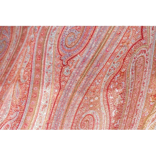 342 - A 19th century Paisley bed cover, in shades of red, pink and green, 154cm by 314cm