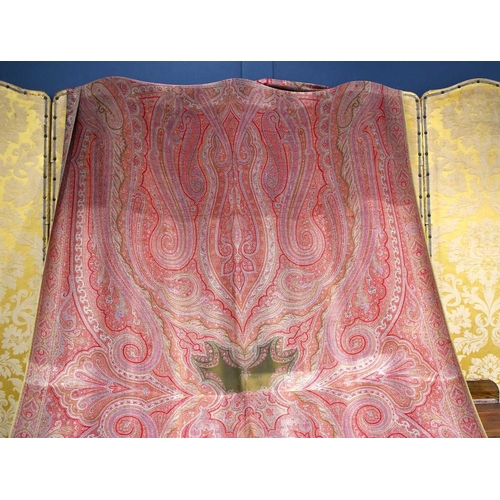 342 - A 19th century Paisley bed cover, in shades of red, pink and green, 154cm by 314cm