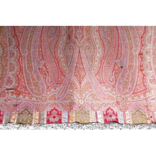 342 - A 19th century Paisley bed cover, in shades of red, pink and green, 154cm by 314cm