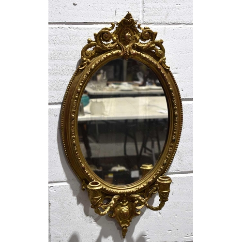 374 - A 19th century giltwood and gesso girandole mirror, with two scrolled branches and decorated with fo... 