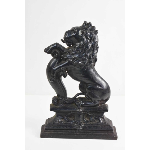 381 - A Victorian cast iron Country House door stop in the form of a lion sejant.