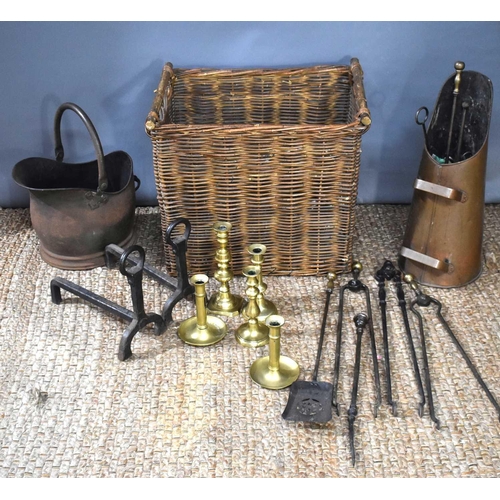 386 - A wicker basket containing a group of metalware to include a copper coal bucket, 19th century wrough... 