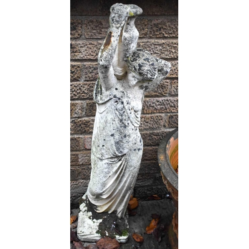 484 - A garden statue, reconstituted stone, in the form of a woman carrying a ewer.