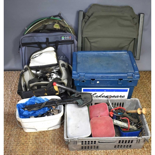 486 - A large group of fishing tackle to include fishing reels, shakespeare tackle box, fishing chair, kee... 