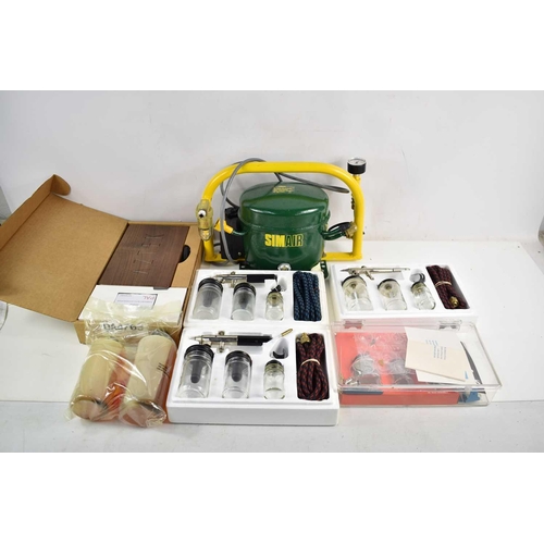 491 - A Simair air compressor together with various airbrush kits to include Thayer & Chandler, Aztek and ... 