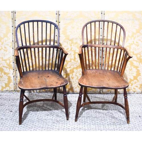 502 - A near pair of 19th century Windsor armchairs, the hoop back above bowed arm rail united by spindles... 