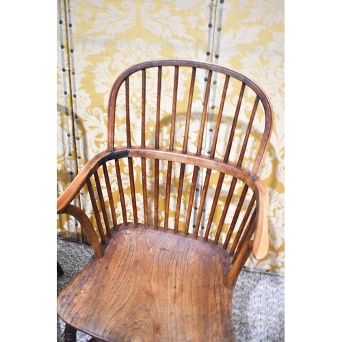 502 - A near pair of 19th century Windsor armchairs, the hoop back above bowed arm rail united by spindles... 