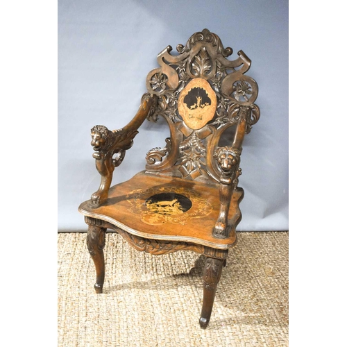 512 - A 19th century Blackforest 'musical' chair (lacking musical mechanism) the decoratively carved back ... 