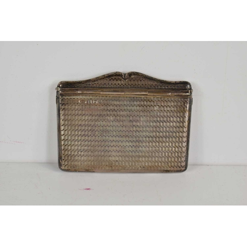 7 - An unusual silver card case of rectangular form with spring loaded hinge and engine turned decoratio... 