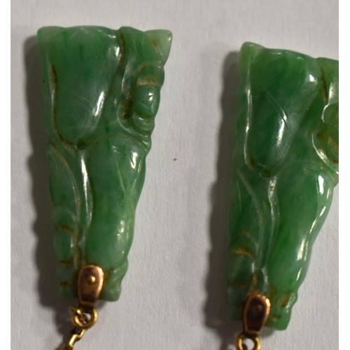 236 - A gold and carved jade pendant, (tested as 9ct) together with a 9ct white gold and jade bar brooch.