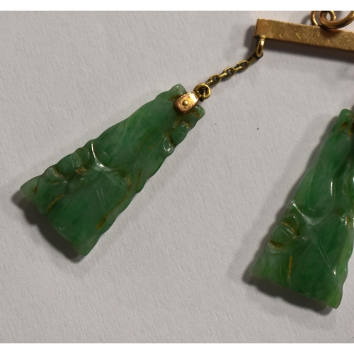 236 - A gold and carved jade pendant, (tested as 9ct) together with a 9ct white gold and jade bar brooch.