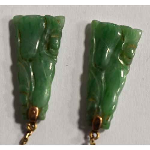 236 - A gold and carved jade pendant, (tested as 9ct) together with a 9ct white gold and jade bar brooch.