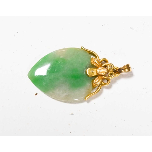 149 - An 18ct gold and jade pendant, the heart form jade with a floral surmount and hoop, 3cm total length... 