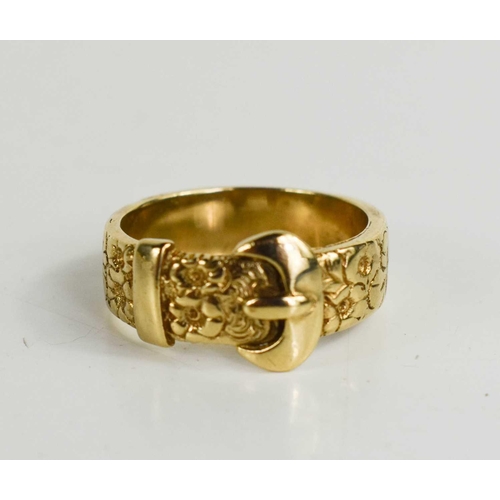 157 - A 9ct gold ring in the form of a buckle, cast with decoration, size T/U, 7.5g.