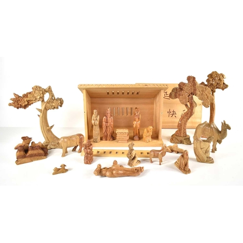 254 - A Chinese carved wooden nativity set to include Jesus, Mary, Joseph, three wise men and others.