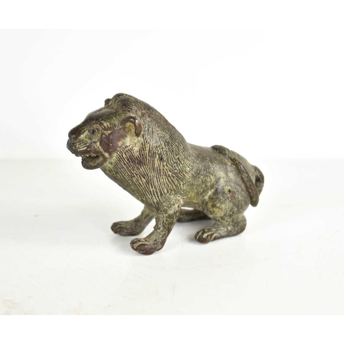 260 - An early bronze lion, with areas of green patination, incised with details to the face and fur, 8cm ... 