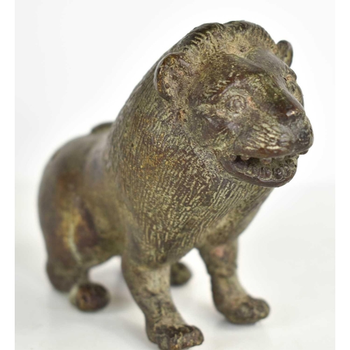 260 - An early bronze lion, with areas of green patination, incised with details to the face and fur, 8cm ... 