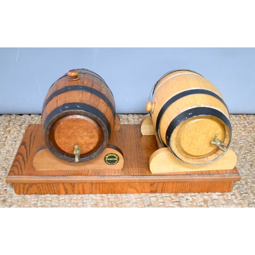 72 - Two German wine barrels, by Schmeiders Copperage Alexandra St, Bundaberg, with a wooden stand