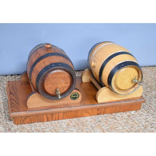 72 - Two German wine barrels, by Schmeiders Copperage Alexandra St, Bundaberg, with a wooden stand