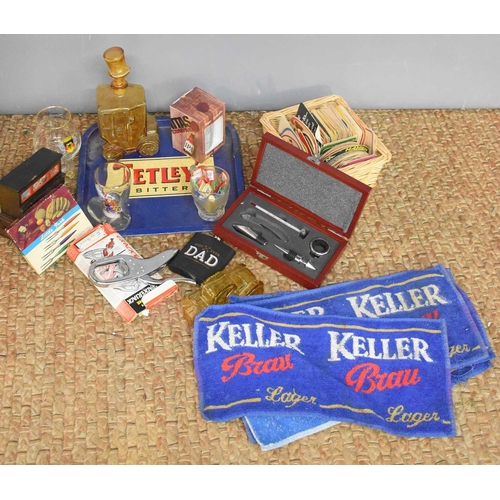 73 - A selection of vintage brewerania, including beer mats, bar towels, Tetleys tray, decanter, nutcrack... 