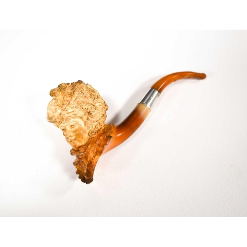 86 - A 19th century meerschaum pipe in the form of a lady wearing a bonnet with plumes of feathers and a ... 