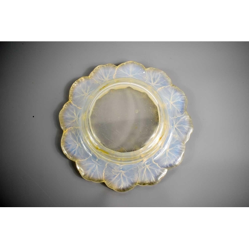 142 - A Rene Lalique glass dish, with repeating leaf design impressed to the rim, signed to the base, 22cm... 