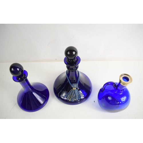 164 - Three Bristol blue glass decanters to include 19th century ship`s decanter with stopper, 25cm and a ... 