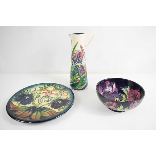 175 - Three examples of Moorcroft pottery, to include a plate in the Hellebore pattern by Nicola Slaney, b... 