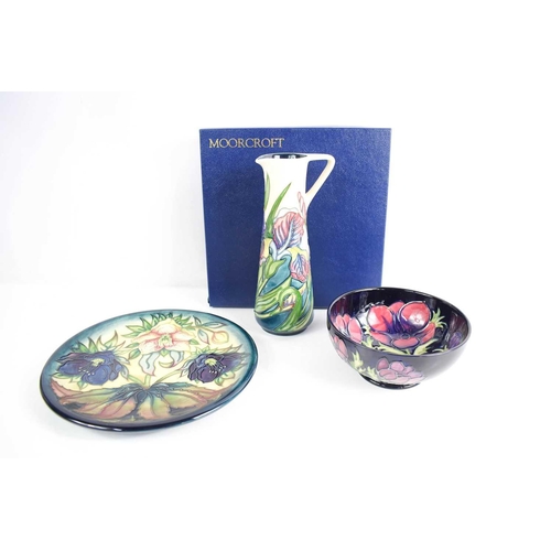 175 - Three examples of Moorcroft pottery, to include a plate in the Hellebore pattern by Nicola Slaney, b... 