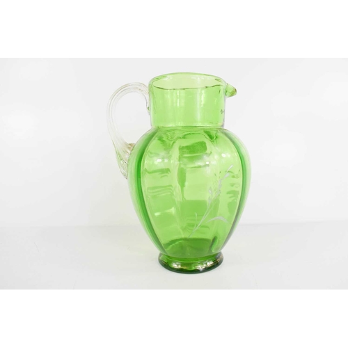 200 - A Victorian green glass Mary Gregory decorated jug, 15cm high.