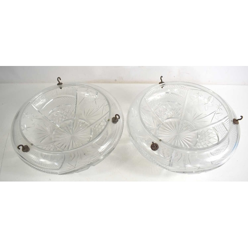 242 - Two 1930s cut glass ceiling shades, the heavy ovoid forms engraved with decoration, and having three... 