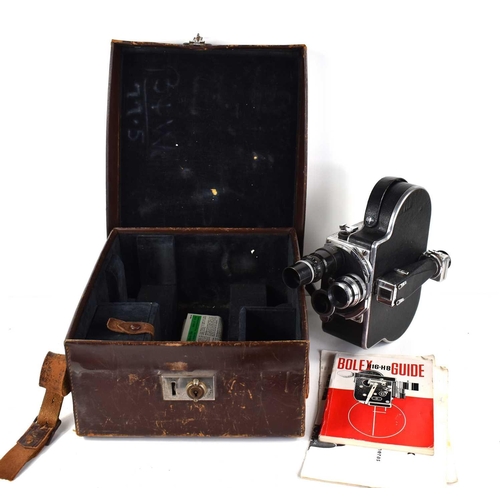 336 - A Paillard Bolex 16mm cine camera, with viewfinder, and three lenses, with some paperwork and in the... 