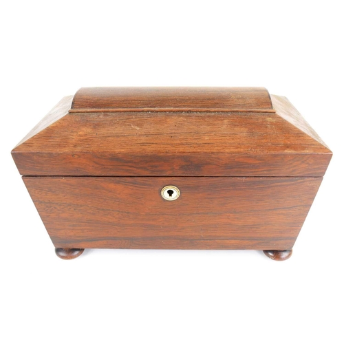 348 - A Victorian rosewood sarcophagus shaped tea caddy, with glass bowl flanked by two lidded compartment... 