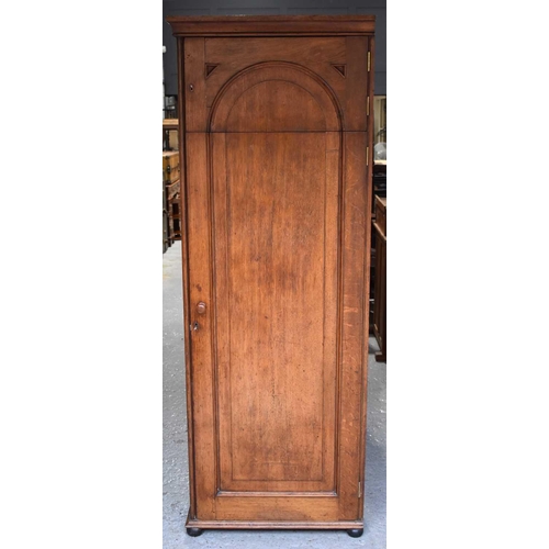 400 - A Victorian oak cabinet of slender proportions, the long panelled door in two sections revealing an ... 