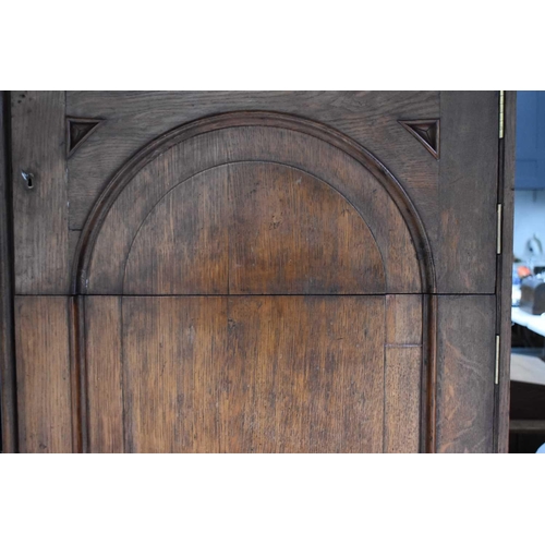 400 - A Victorian oak cabinet of slender proportions, the long panelled door in two sections revealing an ... 