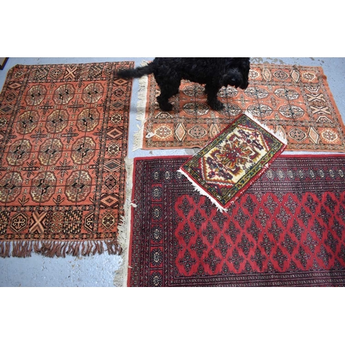 401a - A group of three Middle Eastern wool rugs, with geometric stylised borders together with a wool pray... 